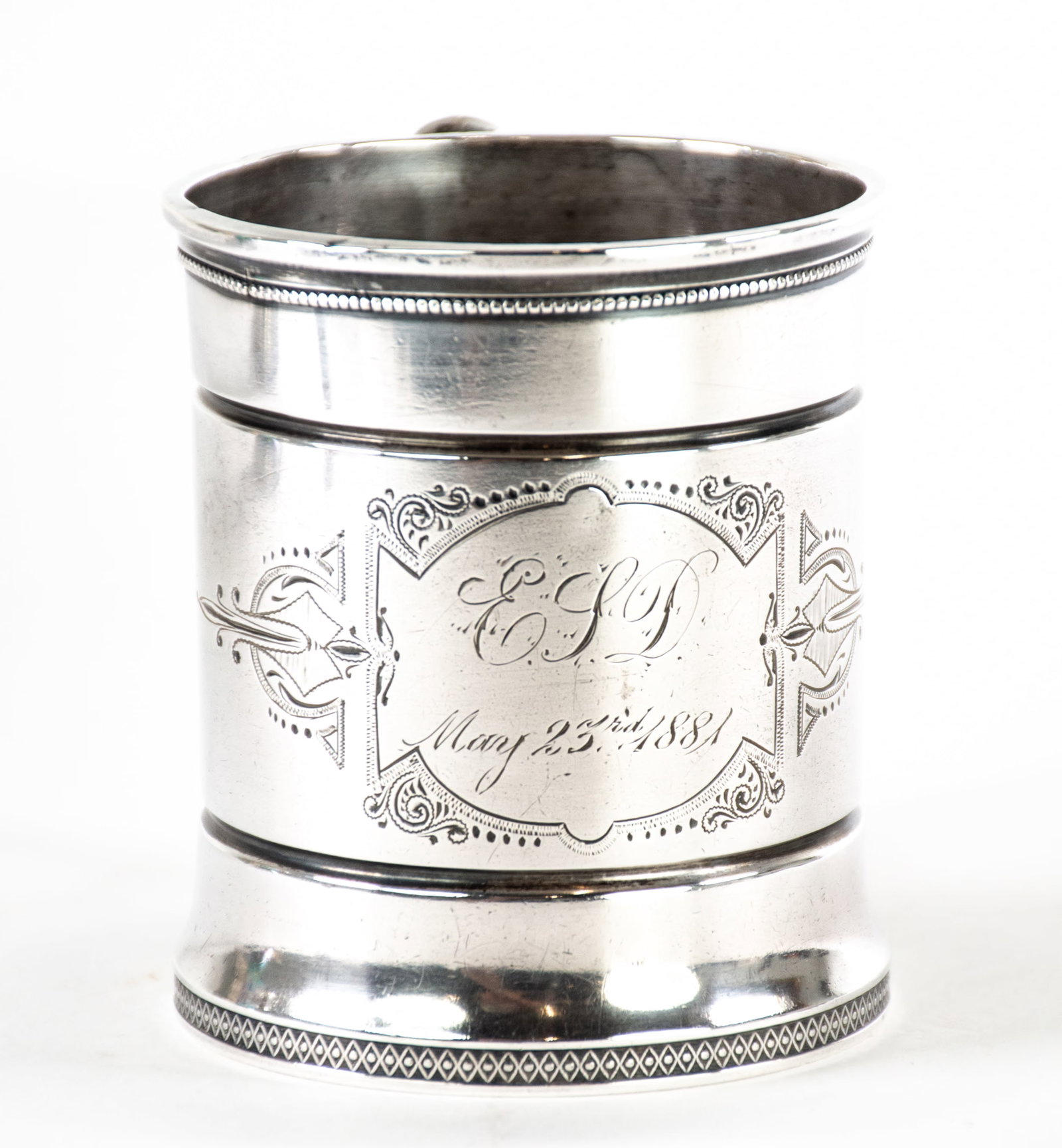 Sterling Silver Mug by Wood & Hughes, New York: Qualifies for in-house shipping---Wood & Hughes (working New York, 1845-1899), front with cartouche engraved "E.L.D. / May 23rd, 1881", beaded edges, marked on underside "W & H / Sterling / 166"; 3