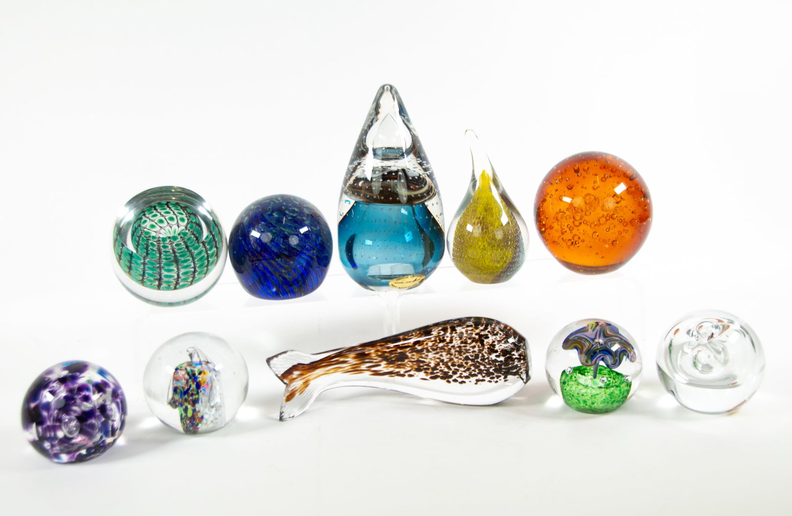 Ten Signed Art Glass Paperweights: Qualifies for in-house shipping---Ball form having abstract green geometric design with cut-out, signed (Tom) "Philabaum 2001"; 3 3/4"W, 3 3/8"H---Ball form with interior bubbles amidst purple and