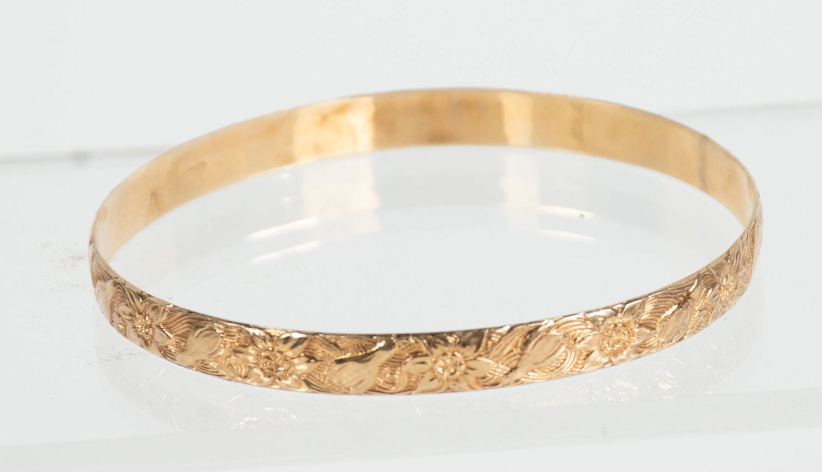 14kt Yellow Gold Bangle Bracelet: Qualifies for in-house shipping---With floral design, marked "Rine 14K"; 1/4"W; interior dia. approx. 2 1/2"---total weight 11.12 grams (Inv. 6-1)