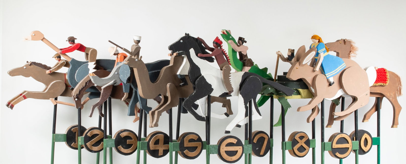 10 Whimsical Horse & Jockey Carved Wood Figures: Qualifies for in-house shipping---Set of whimsical horse and jockey carved and painted wood racing figures; numbered 1 - 10; "horses" depicted as various animals including an elephant, a large bird, a