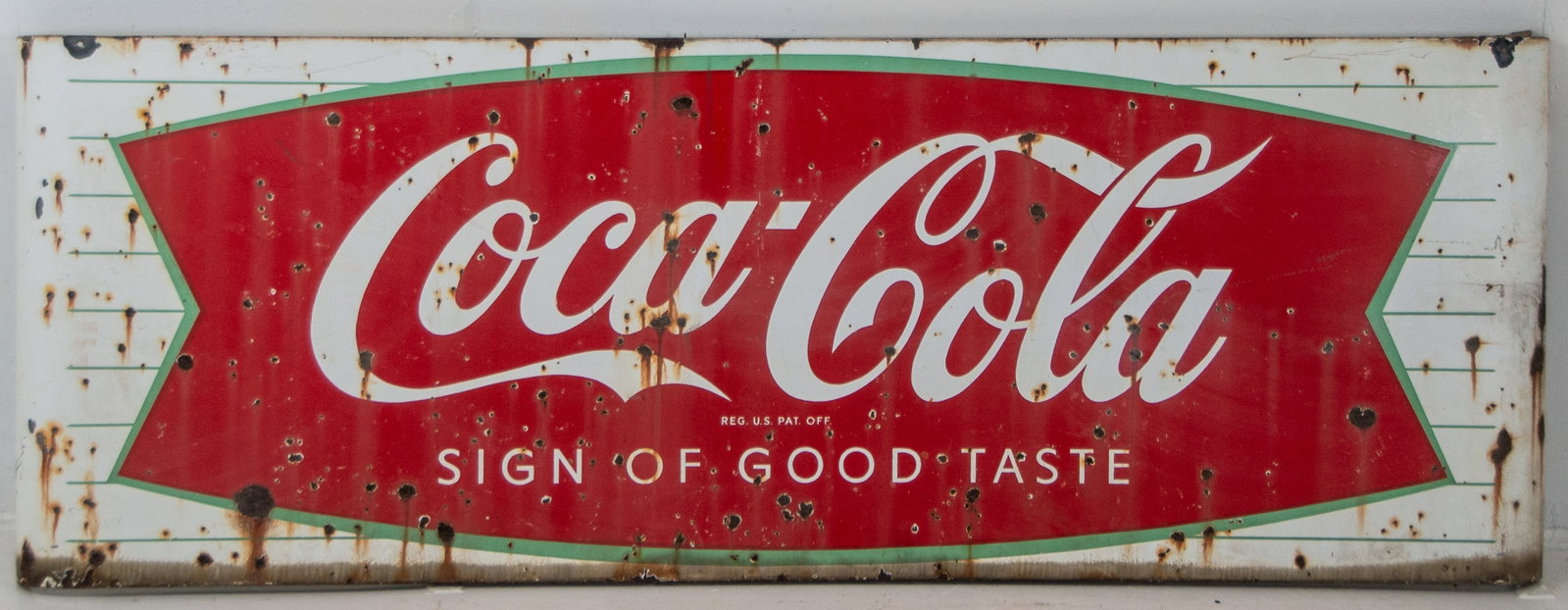 Large Porcelain Coca-Cola Fishtail Sled Sign: Late 1950s / early 1960s, Coca-Cola single-sided porcelain sled sign with "Sign Of Good Taste" tagline, curved ends; 24"H, 67"W---overall scattered dings and losses with rusting---This lot does not qu