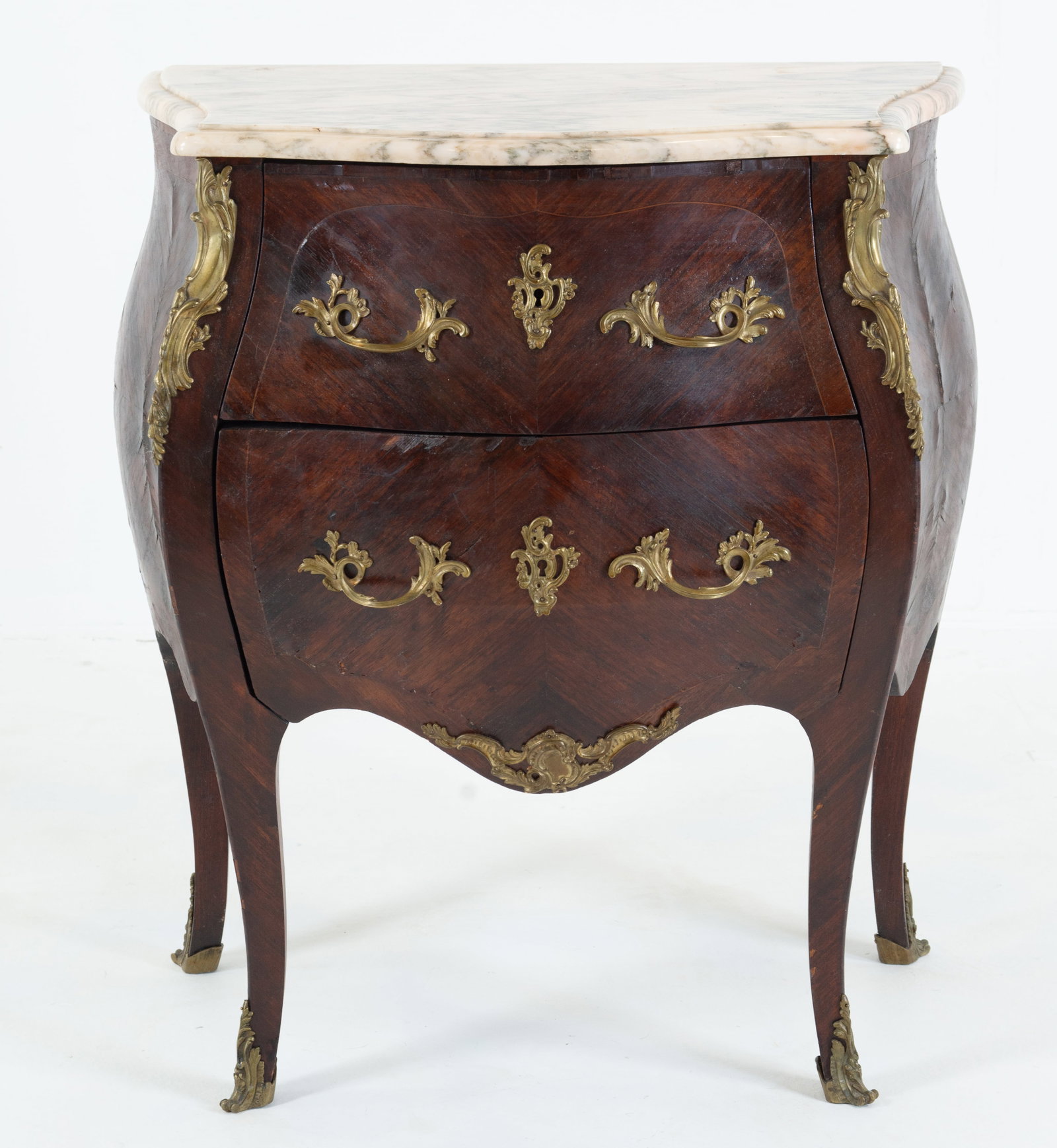 Louis XV Style Bombe Commode: French, 19th century, top with partial paper label "Envoi de E. Kahn & Cie Paris", shaped marble top with molded edge over the bombe case having allover gilt metal handles and accents, two dovetailed