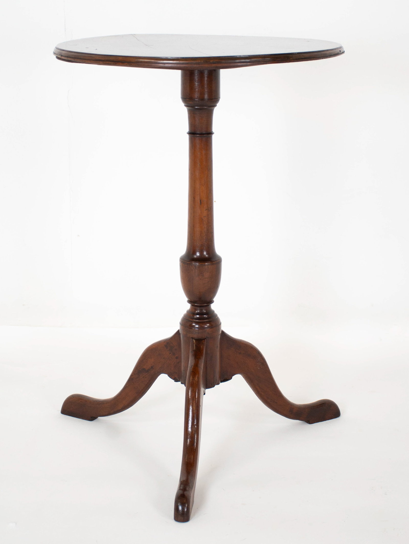Virginia Walnut Candlestand: Late 18th / early 19th century; good form with tripod base, snake pad feet, ring and urn turned standard; tripod base with original wrought iron support; top with molded edge; 19" dia., 28 1/2"H; repa