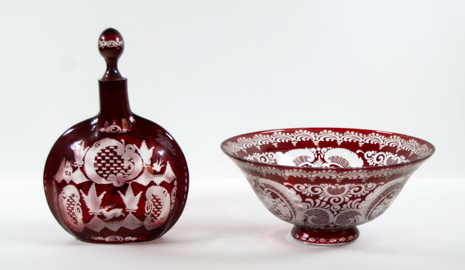 Egermann Bohemian Czech Crystal Bowl & Decanter: Qualifies for in-house shipping---Ruby red cut to clear bowl and decanter, late 20th century---Bowl decorated with scrolled cartouches containing floral sprays alternating with other scrolling foliate