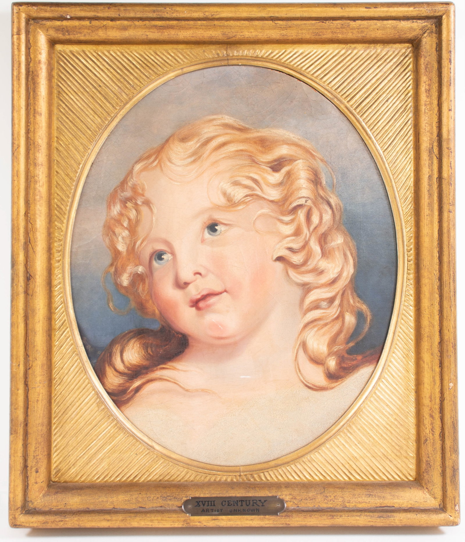18th C. Portrait of a Child: Qualifies for in-house shipping---Oil on canvas, oval portrait of a young child with blonde hair and blue eyes, probably from a larger painting and now mounted on board, unsigned, in gilt wood frame w