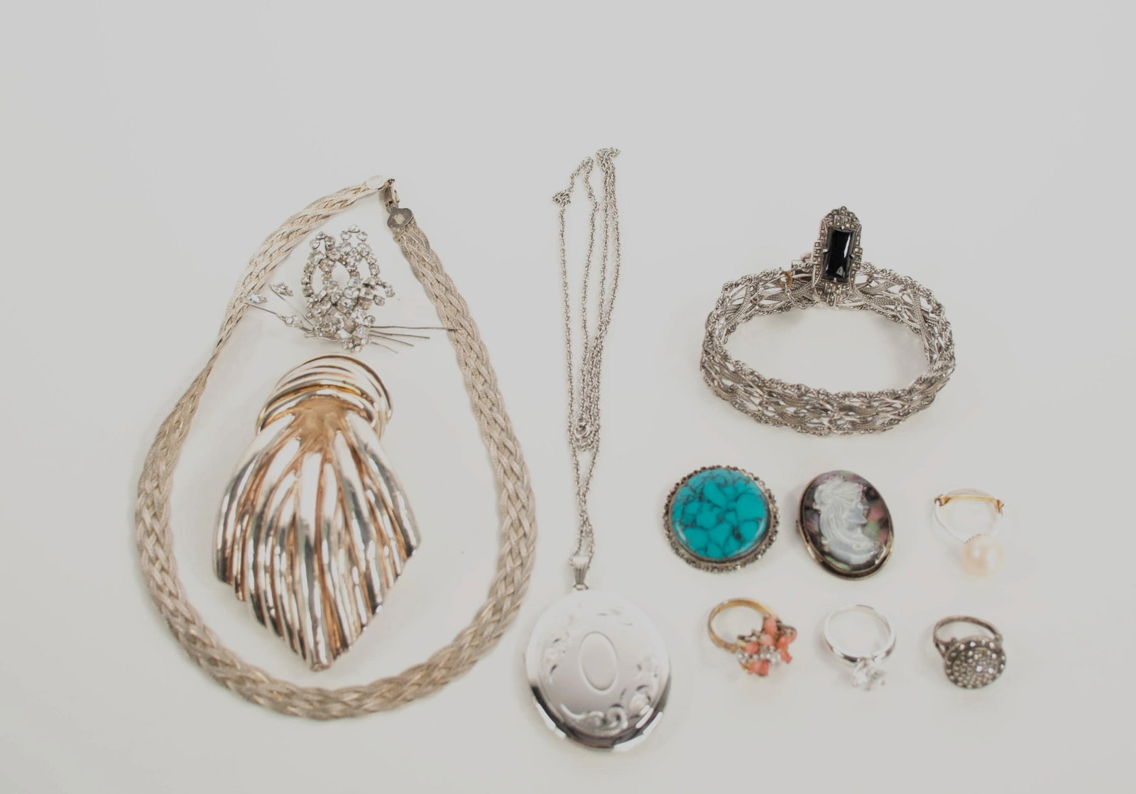 Lot of Sterling Silver Jewelry: Qualifies for in-house shipping---12 pieces: 1. Large pendant / brooch in the form of an ascot, marked "925"; 4"L, 2 1/4"W---2. Openwork link and woven bracelet with safety chain, marked "ER Sterling"