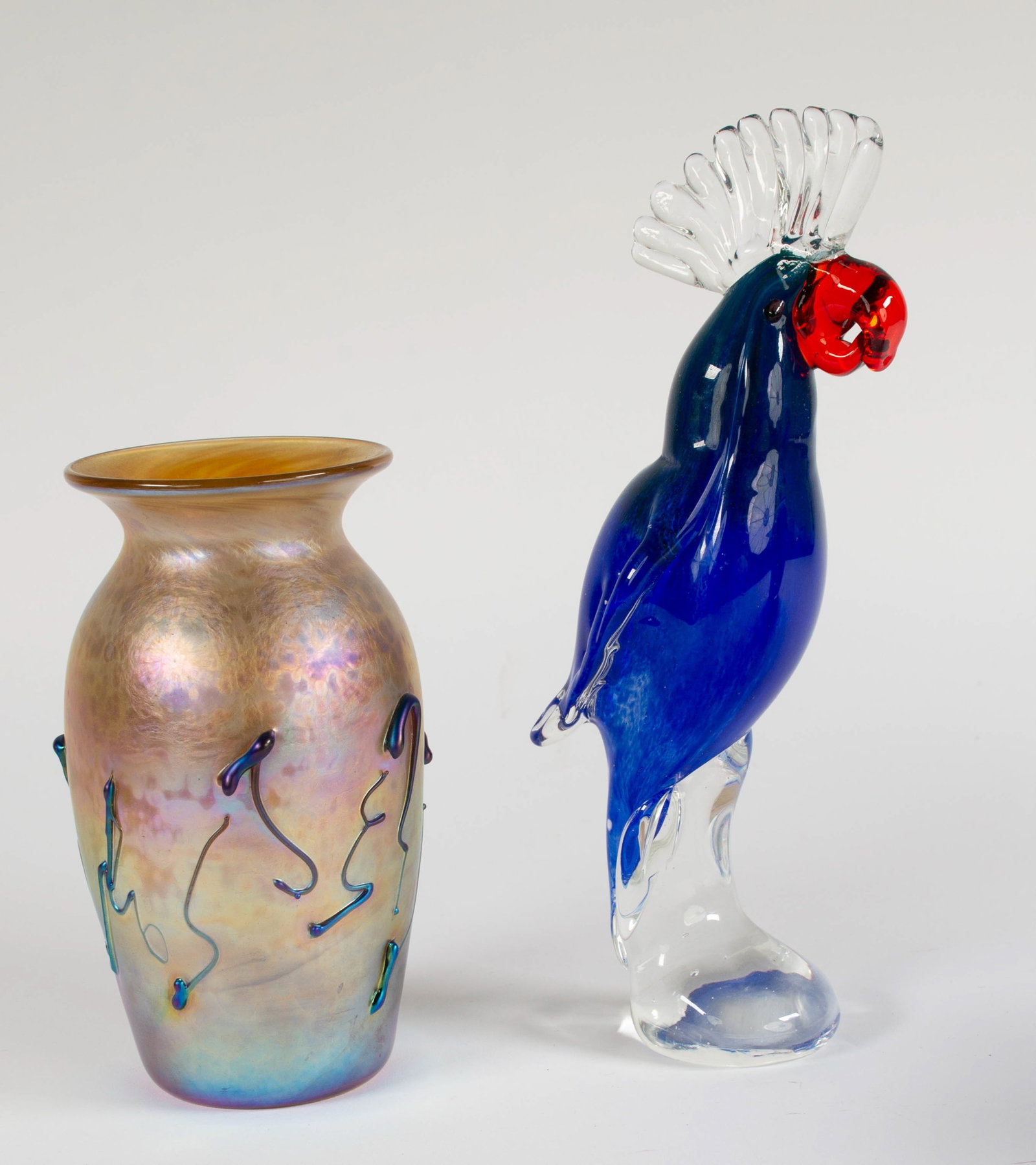 2 Pcs. of Art Glass---Vase and Cockatoo: Qualifies for in-house shipping---1. Roger Roland gold iridescent vase with applied blue decoration, signed "Roland V-1454-87"; 6 5/8"H---2. Murano colorful art glass cockatoo; 9 7/8"H---both in good 