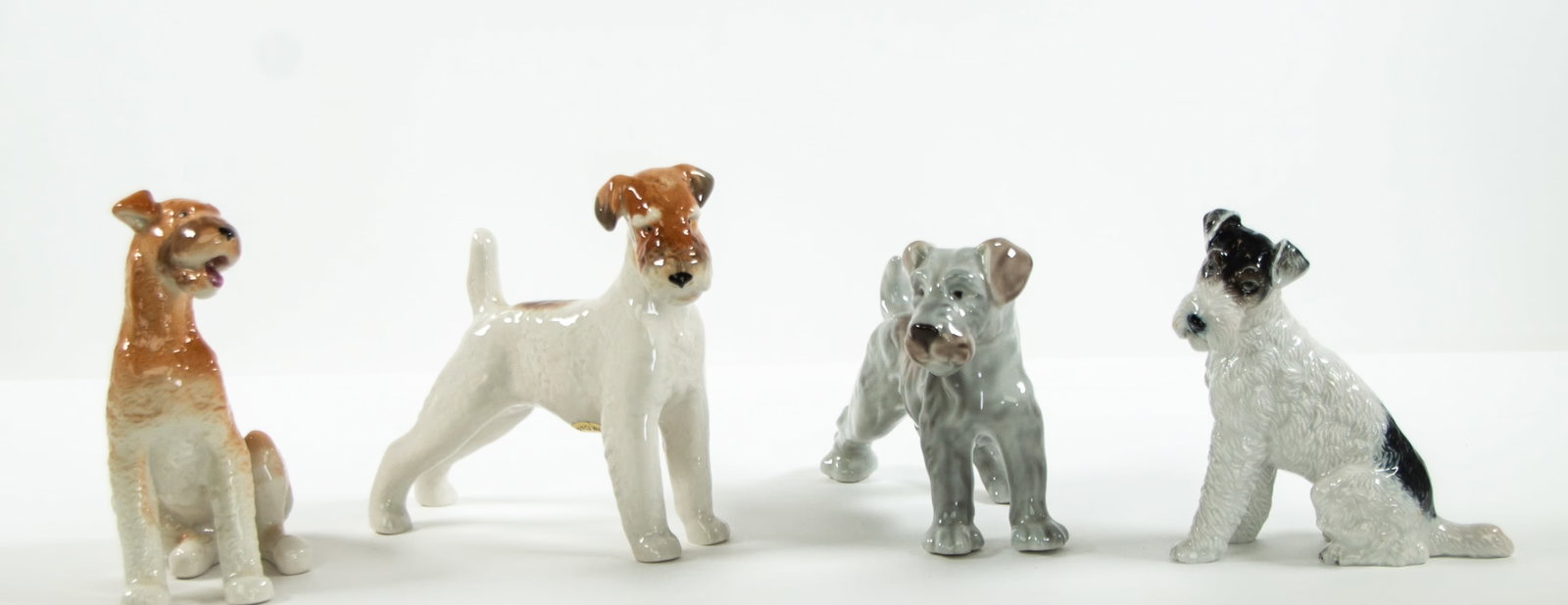 Rosenthal, Lomonosov Porcelain Dog Figures: Qualifies for in-house shipping---Rosenthal porcelain Wire Fox Terrier, made in Germany, incised on base "M. H. Fritz 1243"; 6"H, 5 1/2"L---Lomonosov porcelain Airedale Terrier, made in USSR, marked o
