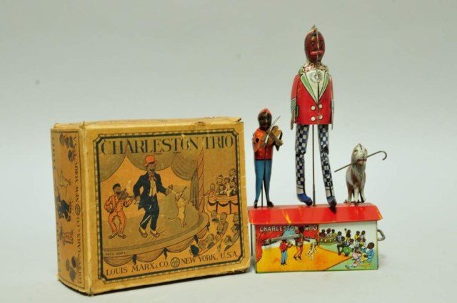 Charleston Trio Wind-Up Toy w/ Box: Black man dancing, boy playing fiddle, and dog jumping on rooftop; tin litho by Louis Marx & Company; box with toning and one end flap missing, residue from label or sticker on one side, creases