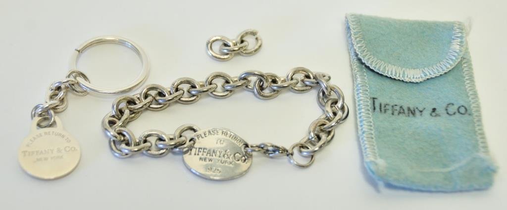 Tiffany Sterling Bracelet & Key Ring: Two items: 1. Sterling silver link chain centering one oval disc engraved "Please Return to Tiffany & Co. New York 925"; 8"L with three extra links; 2. Key ring having round disc suspended from link c