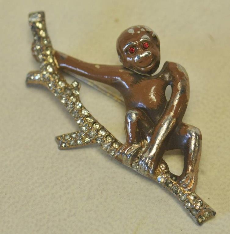 Frank Buck "Bring 'Em Back Alive" Monkey Brooch: Rare c. 1930s, brown enameled monkey with nodder head and red eyes sitting on rhinestone tree branch, signed on back "Bring 'em back alive Frank Buck", from a series of animal brooches representing th