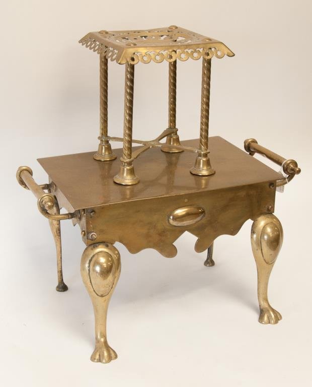 2 English Brass Fireplace Trivets: Lot of two 19th c. English brass fireplace trivets: 1. Large rectangular trivet having oval medallion on shaped skirt, paw feet on front cabriole legs, two handles; 20 1/2"W, 11"D, 12"H; dents to hand