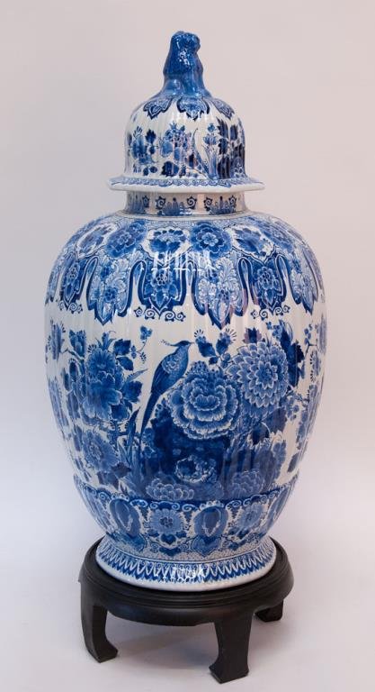 Monumental Delft Ginger Jar: Hand painted blue and white delft ginger jar, cover with lion finial, De Porceleyne Fles mark to base, on black wood stand; 36"H overall, 14" dia., jar 31"H, base 5"H