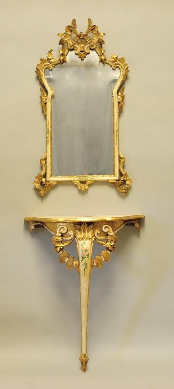Italian Carved Console Table & Mirror: Gilded and painted carved bowfront console table and matching mirror, in the rococo style, probably Florentine; console table 26 1/2"W, 11"D, 31"H; mirror 21"W, 39"H; loss to crest on mirror, console 
