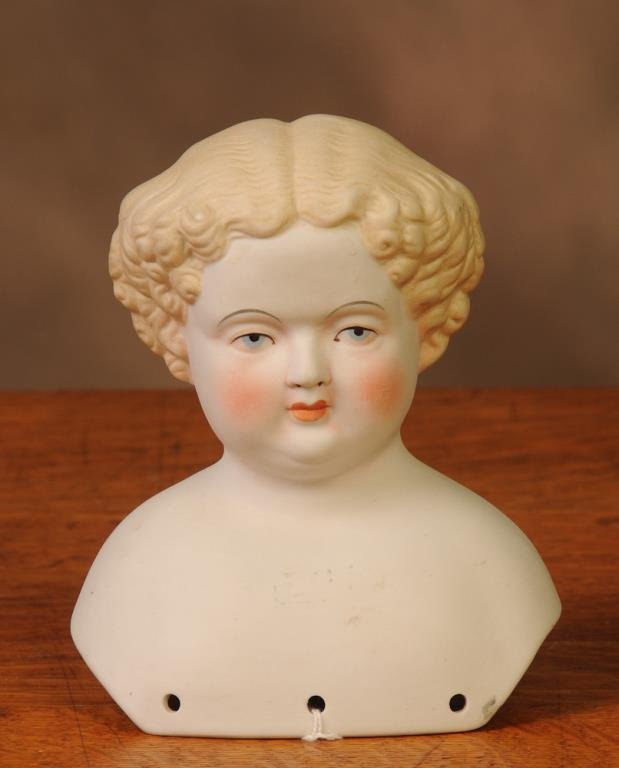 6 1/2" Parian Doll Head: Molded Parian shoulderhead, molded blond hair with center part and curls, arched eyebrows, blue eyes with pink lid lines and red corner eye dots, closed mouth (Inv. 31)--From the collection of Jimmy D