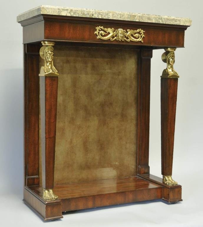Maitland-Smith Egyptian Revival Style Pier Table: Rectangular faux marble top above a frieze with applied gilt mounts, gilt caryatid supports, painted glass back, blocked plinth base; Maitland-Smith label on back; 28"W, 13 1/2"D, 34"H