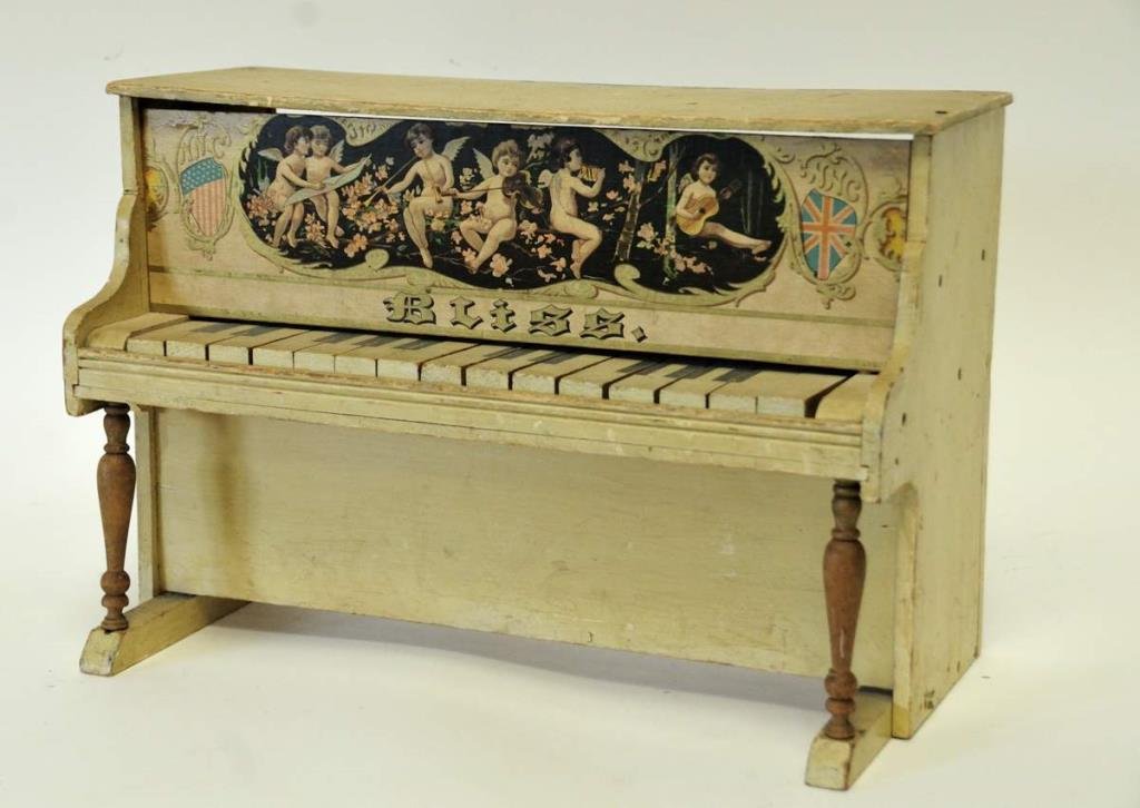 Bliss Wooden Toy Piano: Upright Bliss piano, decals on front of cherubs playing instruments flanked by American flag one side, British flag other side; 17"W, 8 1/4"D, 11 1/4"H; a few keys not working