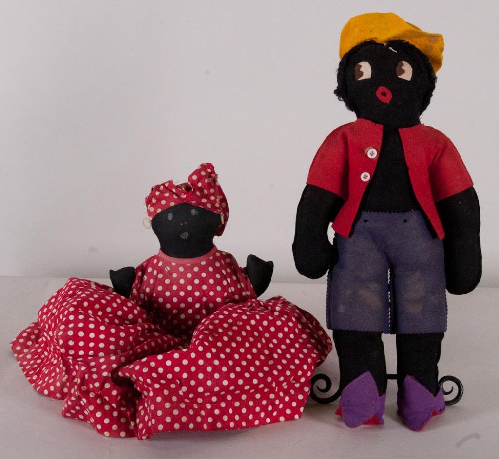 Golliwog and Mammy Dolls: Lot comprised of two dolls--1st item: Golliwog doll; wool felt body, face and clothes, yarn hair; 19"H; some pest damage, soiling/discoloration--2nd item: Mammy tea cozy, black cloth with painted face