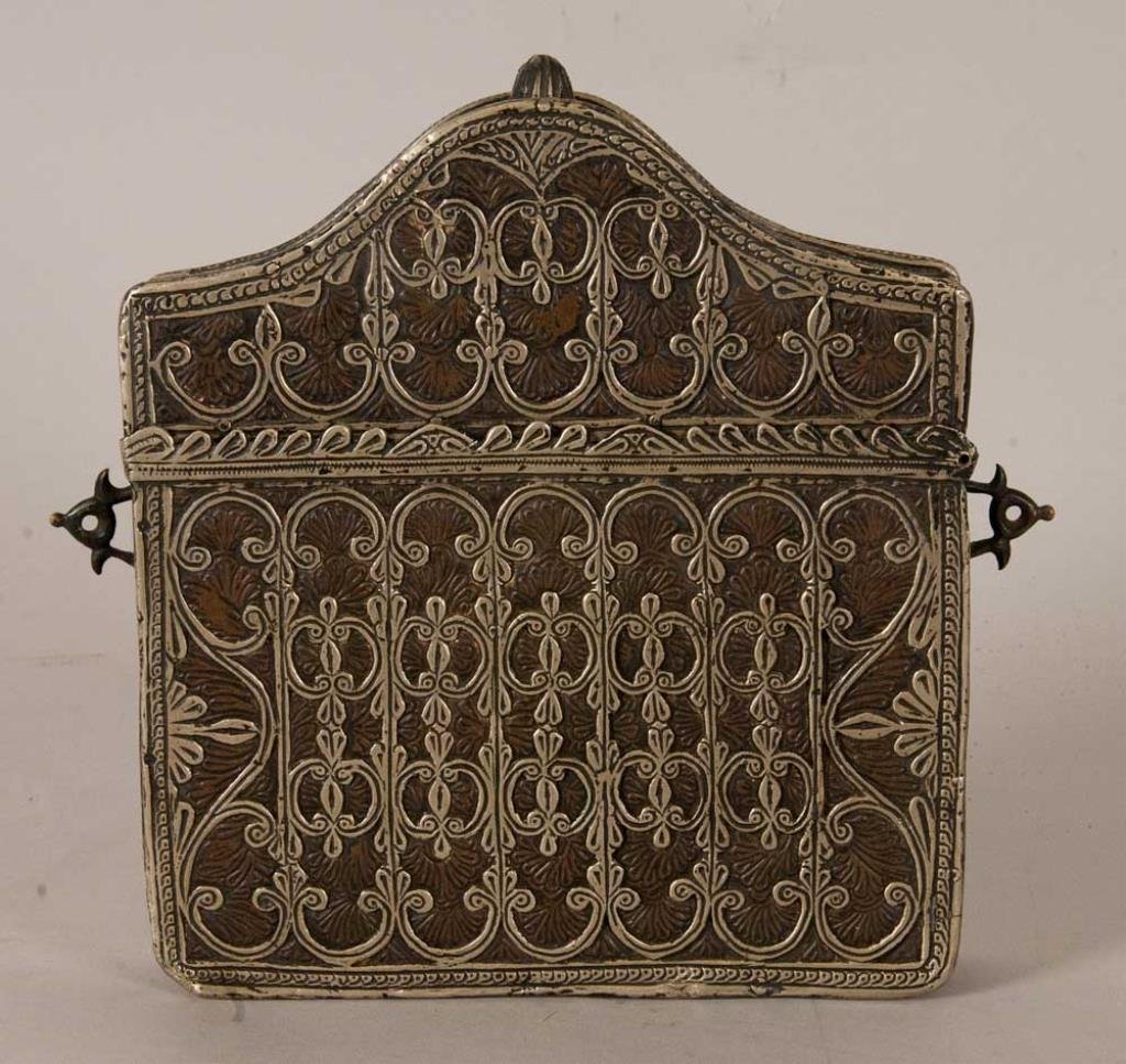 Qur'an (Koran) Case: Islamic Qur'an case purchased by consignor in Egypt, rectangular box having an arched and hinged lid, brass with applied silver components, one side with extensive scrolling foliage, other side with i