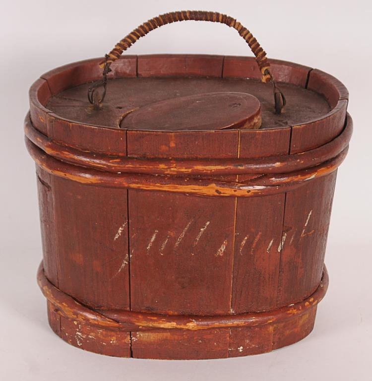 Early Red Painted Minnow Bucket Oval wooden minnow: Oval wooden minnow bucket with original red paint having remnants of white lettering to both sides, probably New England, late 18th/early 19th century, stave and hoop construction with leather wrapped