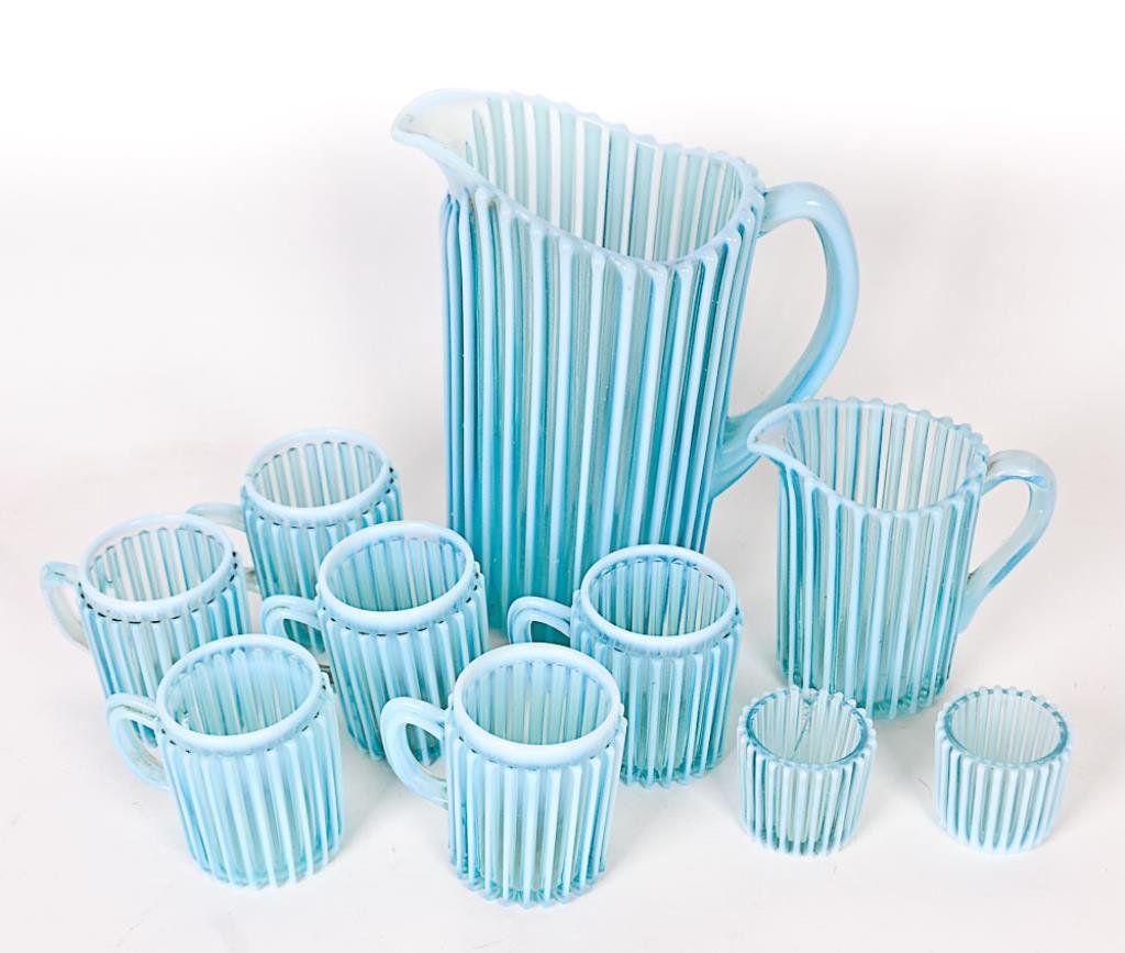 A. J. Beatty Opalescent Glass Pieces Lot of ten Beatty: Lot of ten Beatty Rib blue opalescent glass pieces including a 9"H pitcher, six 3 1/4"H matching mugs, a 4 3/4"H creamer, two 2"H toothpick holders; A. J. Beatty & Sons, fourth quarter 19th century; o