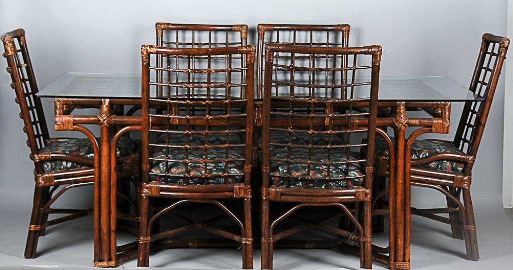 Rattan Dining Table & 6 Chairs Table with glass top: Table with glass top above a conjoined rattan base with central stretcher; 40"W, 76"L, 30 1/2"H; together with six matching side chairs having upholstered seats; 18 1/2"W, 19"D, 39 1/2"H, seat 19"H; o