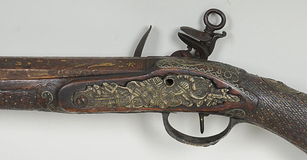 18th C. Miquelet Flint Lock Rifle Heavily inlaid stock: Heavily inlaid stock and barrel, llave a la moda or Madrid style lock, bearing a brass punzon; 64"L; losses to inlay, stock, adornments