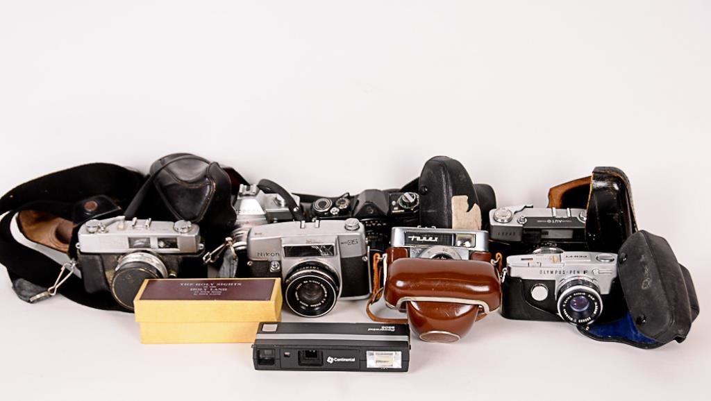 8 Vintage Cameras + Box of Slides Zeiss Ikon Tenax,: Zeiss Ikon Tenax, Unirex Topcon, Heiland Pentax, Continental Powerwind 950S, Olympus Pen F, Konica Auto SZ, Taron Auto EE, Nikon Auto 35, box of 60 35mm slides "The Holy Sights of the Holy Land at You