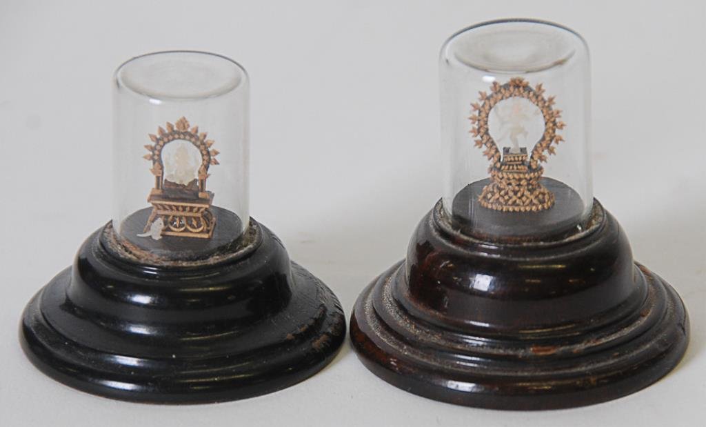 2 Miniature Carvings--Ganesha & Shiva: Two miniature wood and jade or soapstone carvings, both mounted under glass domes with stepped wooden bases (not examined outside of sealed domes)--1st item: Miniature carved figure of Ganesha wearing