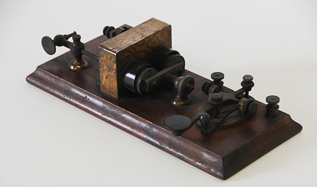 J. H. Bunnell Telegraph Key & Receiver: Wooden base incised "J. H. Bunnell & Co. N.Y." and "35 OHMS / Patented"; 11 1/2" x 5", 3 1/8"H (E1485)