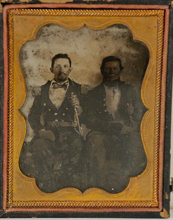 Militia or Early Civil War Ambrotype: Depicting two men in uniforms and holding swords or knives, militia (pre-war) or early Civil War era, 1/4 plate ambrotype in full case, extensive losses to exterior of one side of case