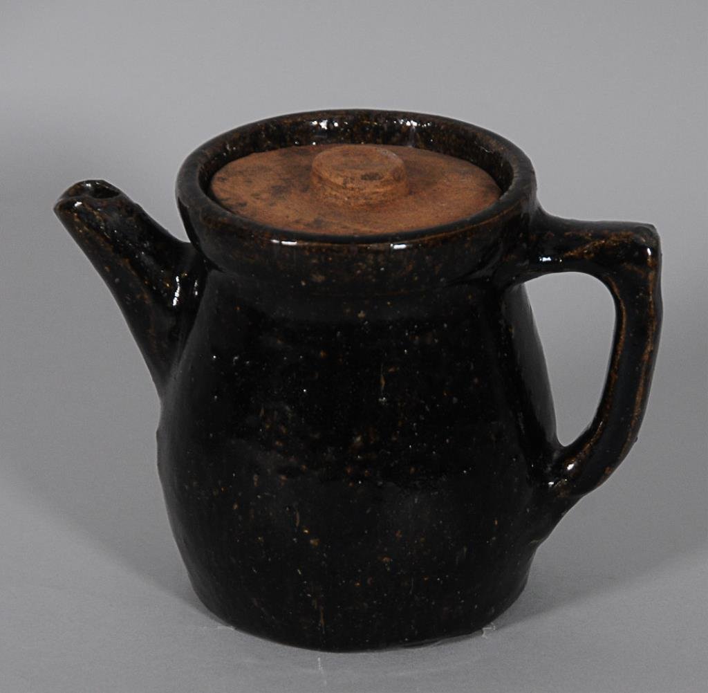 Southern Stoneware Teapot: Dark brown glaze, probably Penland Pottery, Buncombe County, North Carolina; 6"H, 8"W; replaced lid, good condition with glaze void on handle