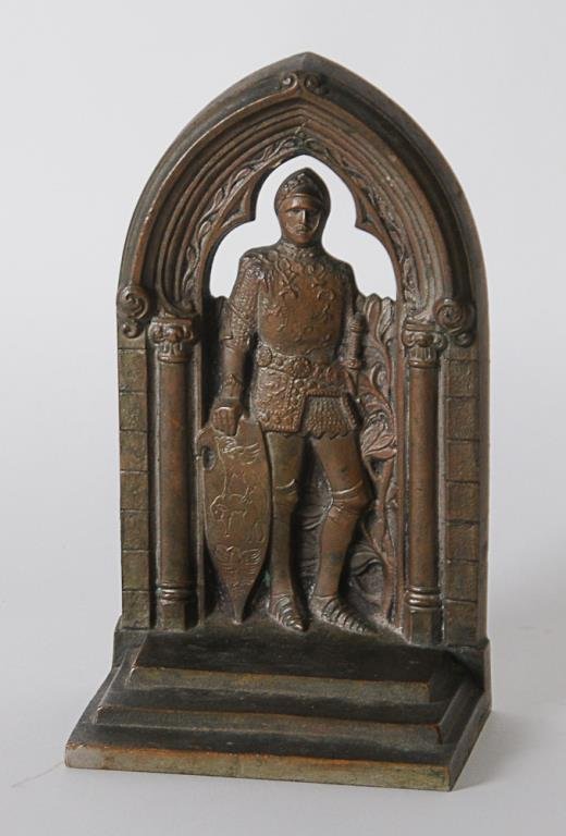 1931 Gorham Travelers Insurance Bookend: Bronze bookend in the form of a knight in armor standing under a Gothic arch, stepped base, verso inscribed "The Travelers / Convention / Palm Beach Florida / 1931"; impressed "Gorham Co. OHTK" and "P