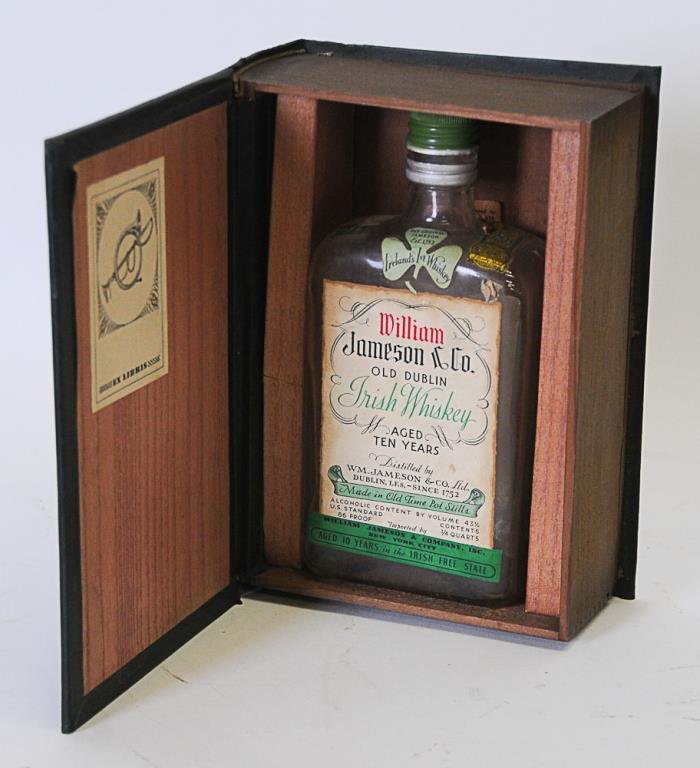 Faux Book w/ Wm. Jameson Irish Whiskey Bottle: Leather covered wood box with hinged lid, designed as faux book with title and author in gilt lettering on spine "Ten Years in the Irish Free State / Limited Edition / William Jameson / Dublin / 1752"