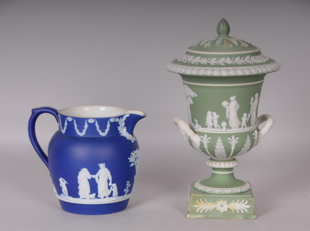 Wedgwood Jasperware Urn and Pitcher: Green Wedgwood jasperware lidded urn, decorated with classical figures and motifs, base incised "Wedgwood", height 9 in.----Dark blue Wedgwood jasperware pitcher, decorated with classical figures and