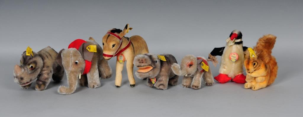 c. 1950s Steiff Miniature Toy Grouping: Seven miniature c. 1950s Steiff toys: Elephant No. 6310, with ear button and ribbon, height 4 in., length 6 in.----"Nosy" rhinoceros No. 1310; with paper name tag, ear button and ribbon; height 3 in.,