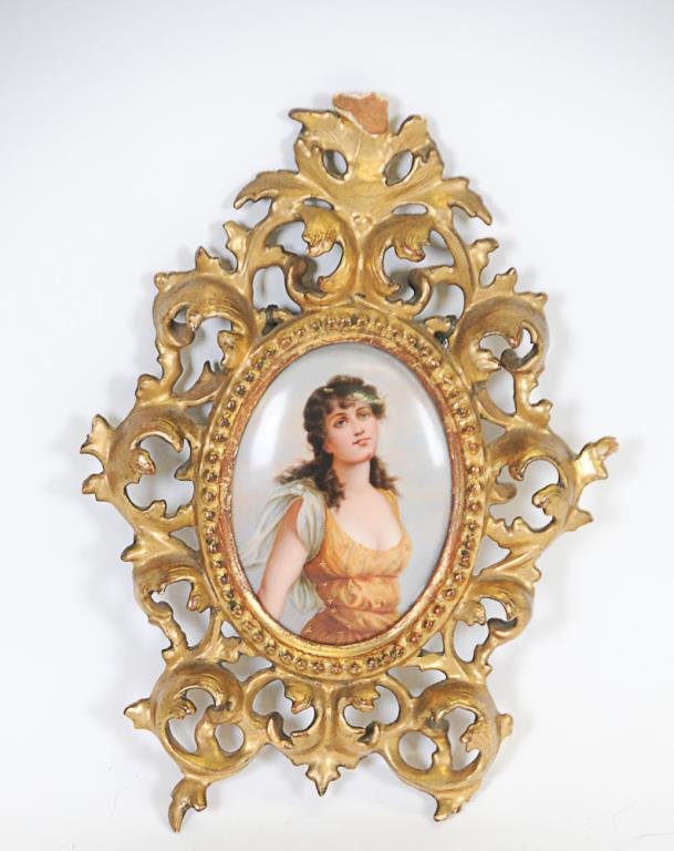 German Portrait Plaque after Thumann: German porcelain portrait plaque after Paul Thumann (German, 1834-1908), oval porcelain plaque hand painted with portrait of young beauty in gold dress with gilt accents, carved and gilt wood Florenti