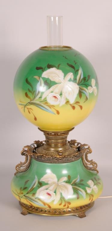 "The Miller Lamp" Parlor Lamp: Late 19th century, matching glass base and shade with hand painted large white flowers on a green to yellow ground, cast metal embossed mount marked "The Miller Lamp Made in U.S.A.", electrified; 23 i