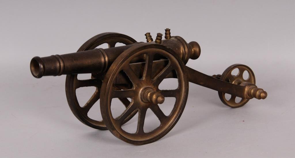 Brass Model of a Cannon: With a brass carriage and eight-spoke wheels; length 10 1/2 in., width 4 in.