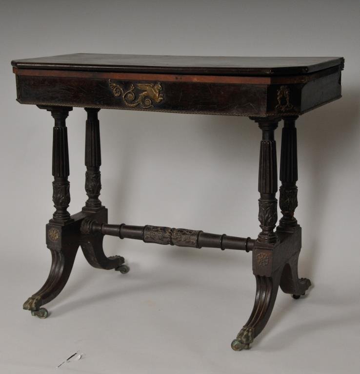 19th C. Regency Ormolu Mounted Games Table: Swivel top over trestle form base, reeded columnar supports and reeded legs ending in metal paw feet with casters, support terminals with acanthus carvings and connected by acanthus carved stretcher, 