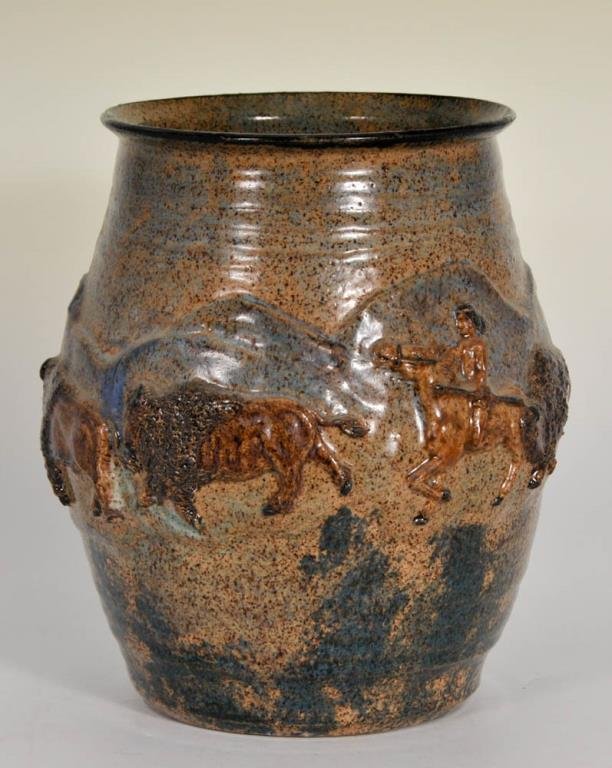 Pottery Vase with Native American Theme: Ovoid vase or storage jar, decorated in relief with one male Native American figure on horseback and three buffalo against a mountainous landscape, signed on bottom "95 Malsnee"; Malsnee Pottery, Wood