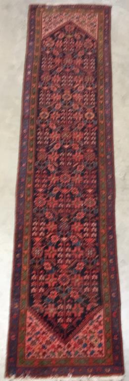Middle Eastern Oriental Runner, 3' x 13': Decorated overall with flowers, arrows, and geometric designs in salmon, blue, rust, and green on a navy field; floral borders; 3' x 13'; medium to low pile, repair at one end