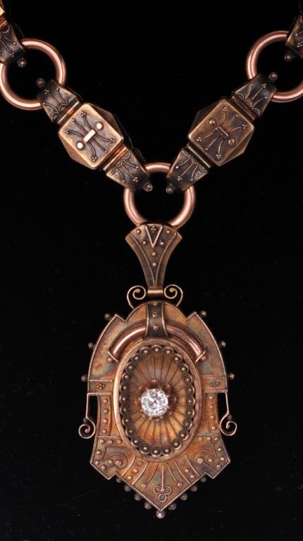 Etruscan Revival Necklace w/ 1ct Mine-Cut Diamond: Late 19th century; Etruscan Revival locket pendant centers an old mine-cut diamond approx. 1ct surrounded by applied metal decorative accents, back of locket with presentation engraving dated Dec. 25t