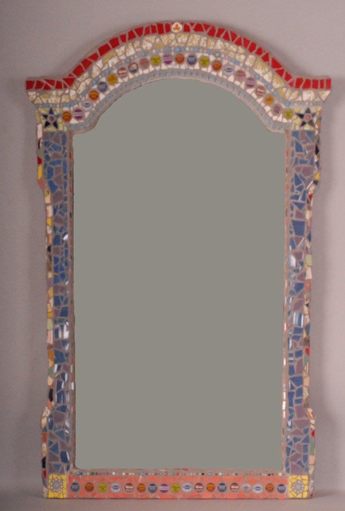 Late 20th Century Folk Art Mirror: Rectangular mirror with arched top and shaped sides, arched top and bottom bordered with row of soda bottle caps, all sides decorated with multi-color porcelain shards; 31 1/2"W x 49 1/4"H (Ref. 420)