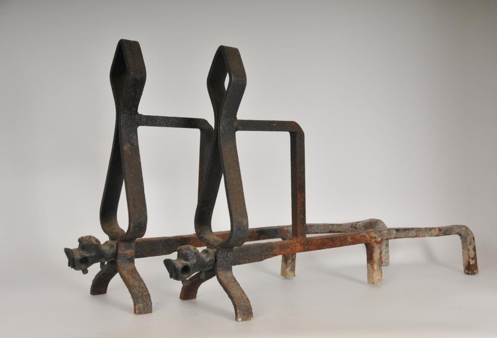 Pair of Unusual Hippopotamus Head Andirons: Pair of wrought iron andirons, upright formed as a rounded diamond shape over a rounded and longer triangle shape with the figural head of a hippopotamus at the base; 17 3/4"H, 7 1/2"W, 28 1/4"D; some