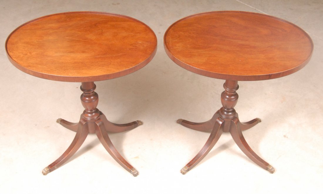 Pr. of Mahogany Duncan Phyfe Style Side Tables: Oval tops with raised banded edge, urn form pedestal, supported on four legs terminating in metal paw feet; 18\" x 24\", 26 1/4\"H; minor veneer losses to banding on one top