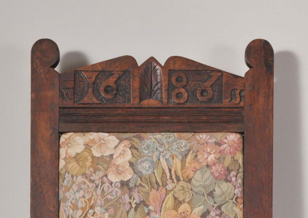 Dated 1686 Cromwellian Carved Oak Chair: Having a rare crest with carved date "1686", mortise and tenon and pegged construction, banded stretcher; 41 1/2"H, 18"W, 15"D, seat 19 3/4"H; later upholstery, repairs