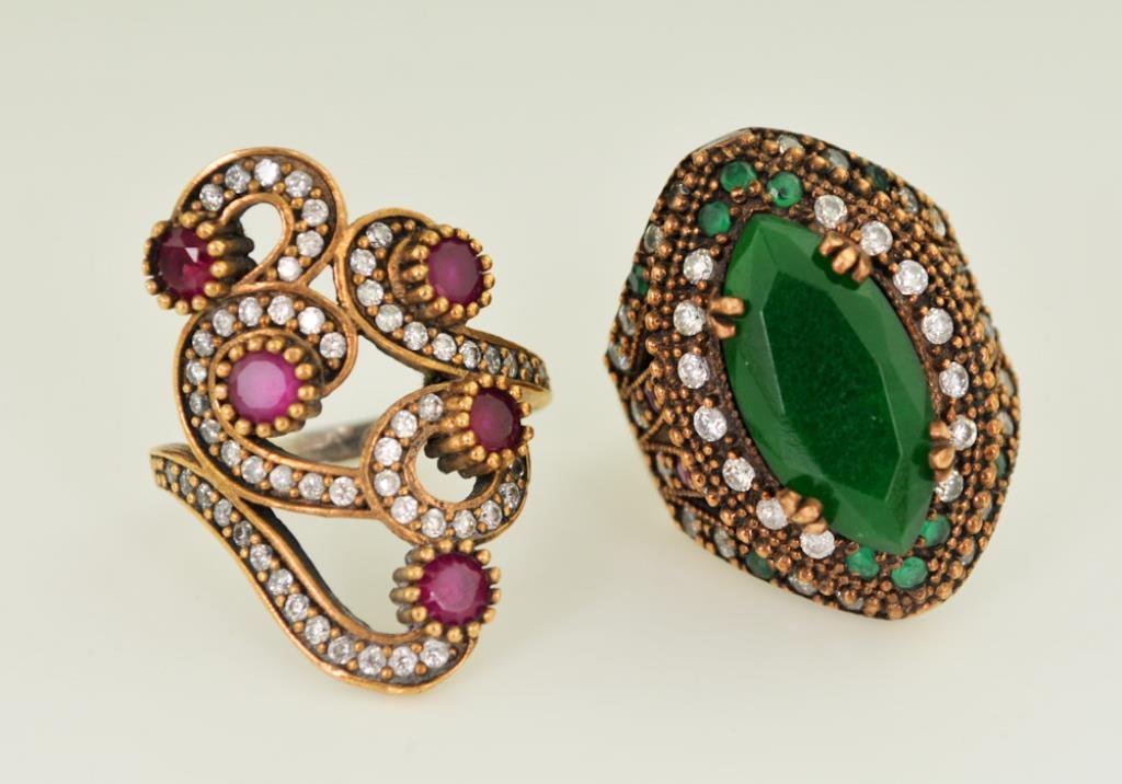 Two Vintage Rings: 1st item: Sterling silver ring by Truva, face having large scrolls set with simulated rubies and diamonds; marked "Truva" and "925"; size 7; face measures approx. 1 3/16" x 3/4"; total weight .200 ozt
