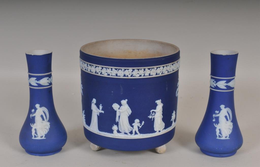3 Pcs. Wedgwood Dark Blue Jasperware: English, late 19th/early 20th century: Footed jardiniere, cylindrical body with morning glory banding over classical figures in relief, marked "Wedgwood" and "England"; 6" dia., 6 3/8"H; good conditio