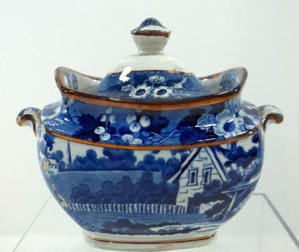 Blue Transfer Staffordshire Sugar Bowl: c1850 "Cottage with Bee Skep", marked Stone China. Condition glaze skips and old lid repair. Measures approx. 5.5" tall. Please Note: This one owner Flow Blue collection is generally in very good cond